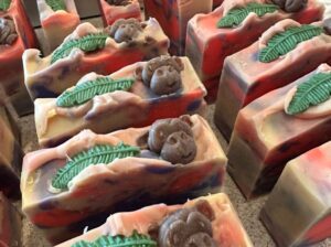 Cut soap with a dominant banana scent, decorated with a tropical leaf and a monkey face.